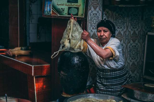 an old woman practicing food preservation in ancient time